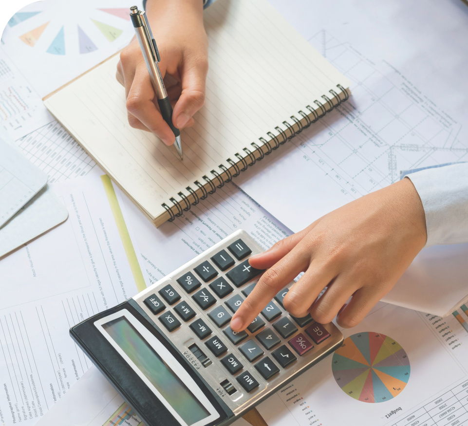 Female using calculator while reviewing reports and notes