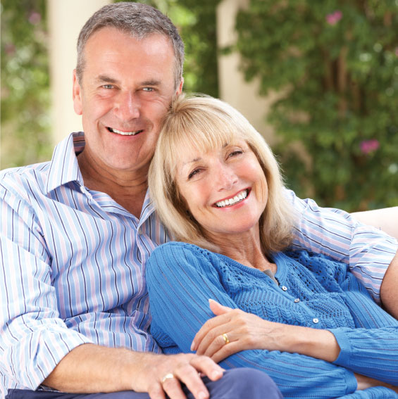 middle-aged-male-and-female-ssb-wealth-management-clients-wearing-blue-and-smiling